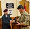 Maj Jim Foster, OC 131 Cdo Sqn, receives the Lonergan Trophy from Maj Robin Ward, former OC of 300 Para Sqn.