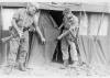 Hughie Craig and John Martin inspecting bullet holes in tent.